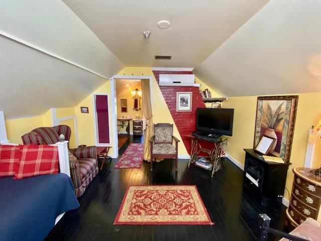 living room featuring dark hardwood / wood-style floors and lofted ceiling