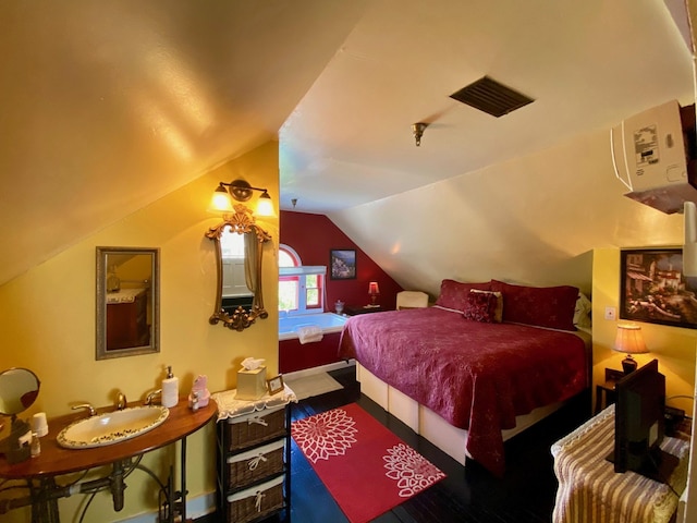 bedroom featuring dark hardwood / wood-style flooring and lofted ceiling