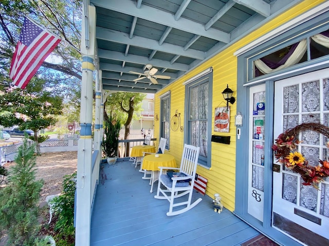 deck with covered porch and ceiling fan