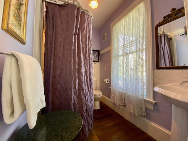 bathroom featuring sink, hardwood / wood-style floors, and toilet