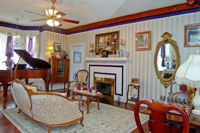 sitting room with ceiling fan and wood-type flooring