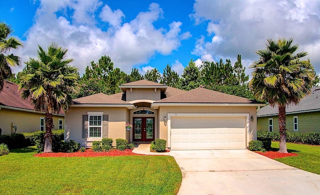 61 Grey Hawk Dr, Saint Augustine, FL 32092 - view of front of home featuring french doors, stucco siding, a garage, and concrete driveway