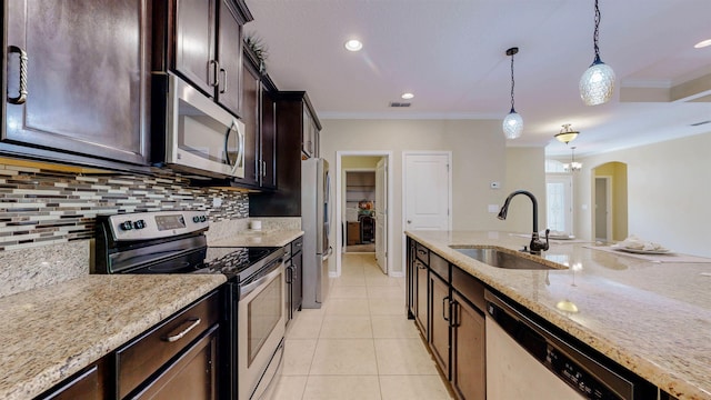 61 Grey Hawk Dr, Saint Augustine, FL 32092 - kitchen with stainless steel appliances, backsplash, decorative light fixtures, dark brown cabinets, and ornamental molding