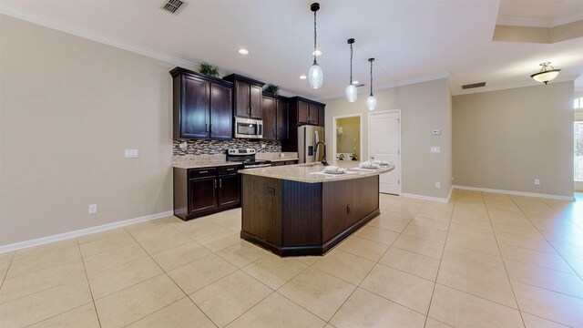 61 Grey Hawk Dr, Saint Augustine, FL 32092 - kitchen with appliances with stainless steel finishes, crown molding, backsplash, light tile patterned floors, and an island with sink