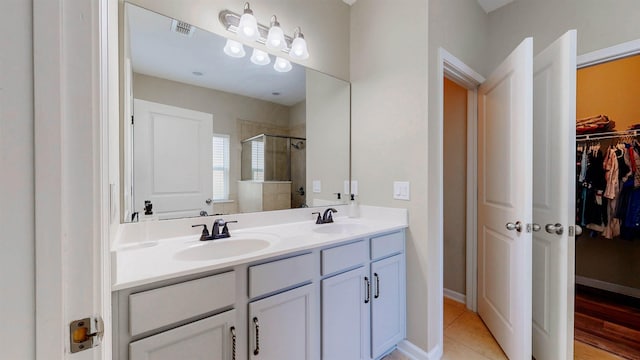 61 Grey Hawk Dr, Saint Augustine, FL 32092 - full bath with a spacious closet, a shower stall, double vanity, and tile patterned flooring