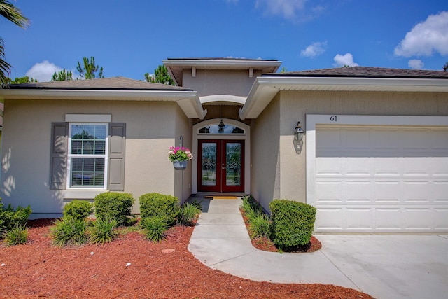 61 Grey Hawk Dr, Saint Augustine, FL 32092 - property entrance with french doors, an attached garage, and stucco siding
