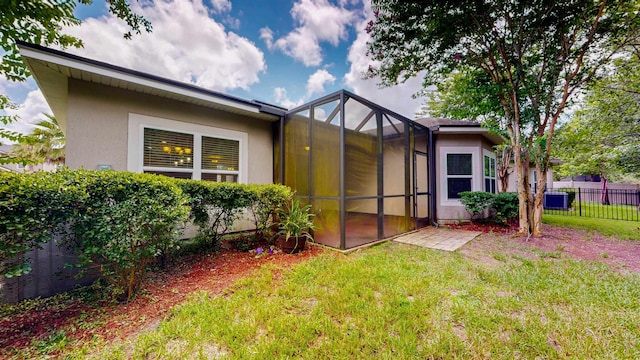 61 Grey Hawk Dr, Saint Augustine, FL 32092 - rear view of house featuring stucco siding and glass enclosure