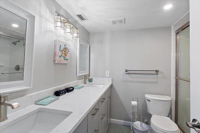 bathroom with vanity, an enclosed shower, and toilet