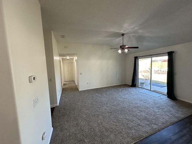 unfurnished room featuring ceiling fan and dark carpet