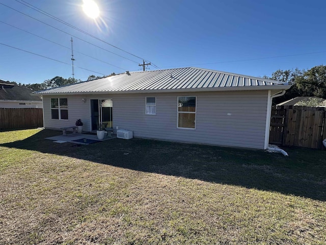 rear view of house featuring a lawn