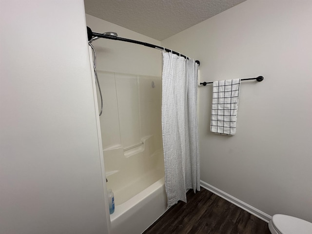 bathroom with a textured ceiling, toilet, shower / bathtub combination with curtain, and wood-type flooring