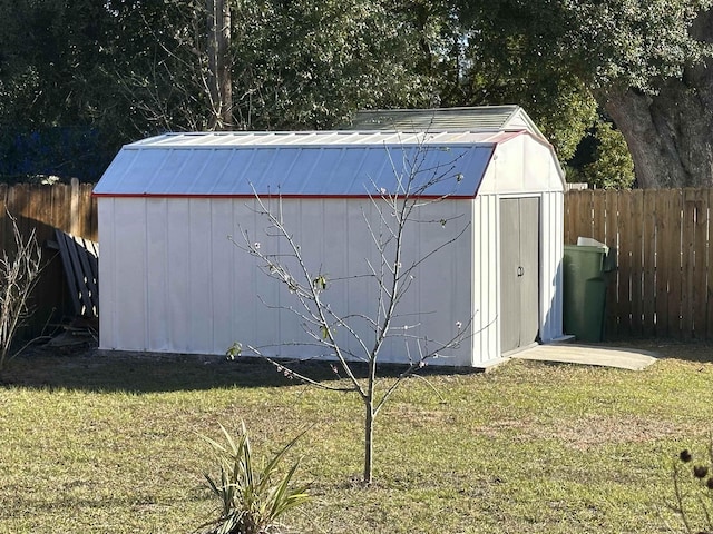 view of outbuilding with a yard