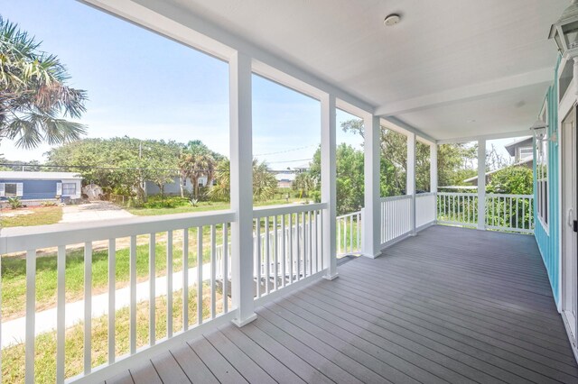 unfurnished sunroom with beam ceiling