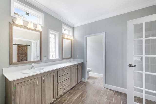 bathroom featuring plenty of natural light, toilet, wood-type flooring, and vanity