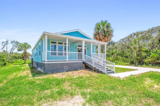 bungalow-style house with a porch and a front lawn