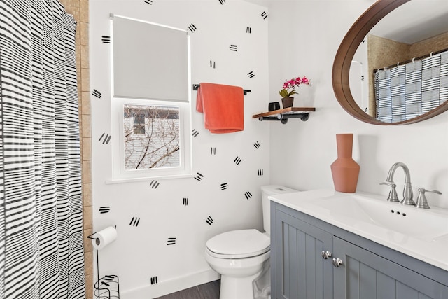 bathroom featuring vanity and toilet