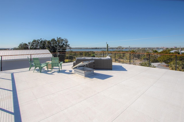 view of patio / terrace featuring a water view and an outdoor living space