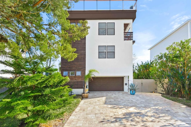 contemporary home with a garage and a balcony