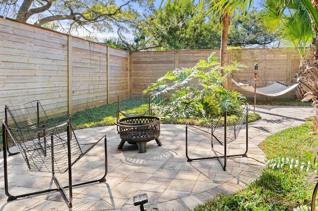 view of patio with a fire pit