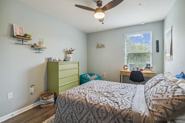 bedroom featuring ceiling fan, hardwood / wood-style floors, and a textured ceiling