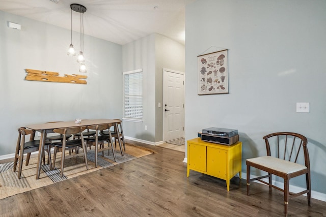 dining space with dark hardwood / wood-style flooring