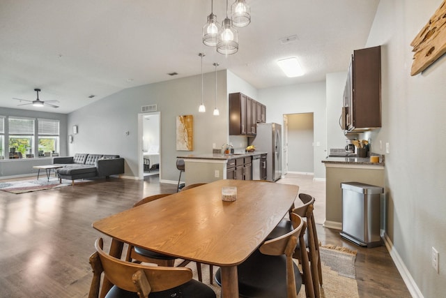 dining space featuring hardwood / wood-style floors, ceiling fan, lofted ceiling, and sink