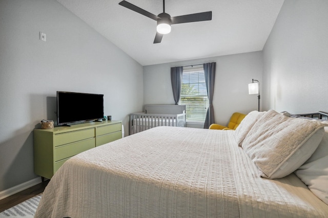 bedroom featuring hardwood / wood-style floors, ceiling fan, and vaulted ceiling