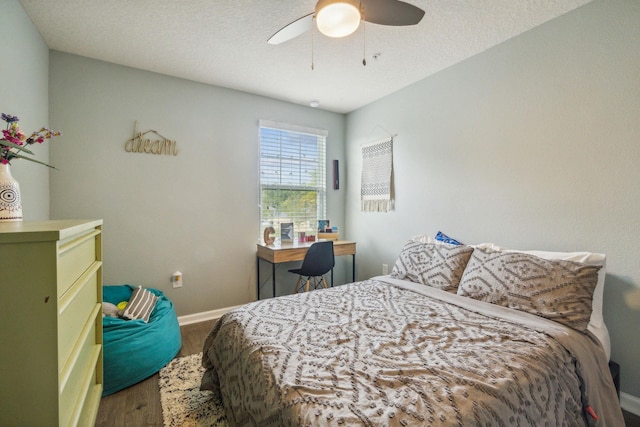 bedroom featuring a textured ceiling, hardwood / wood-style flooring, and ceiling fan