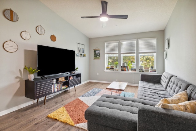 living room featuring wood-type flooring, high vaulted ceiling, and ceiling fan