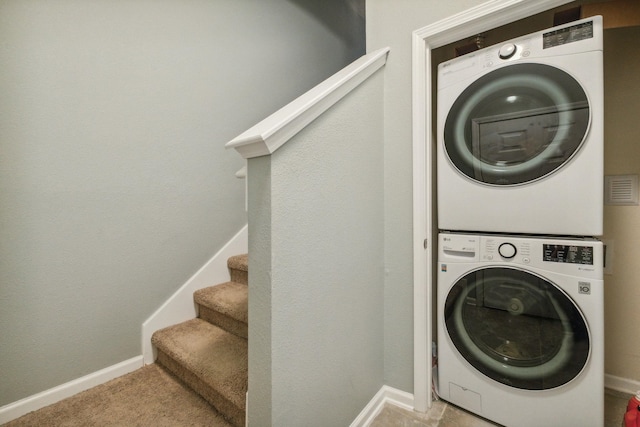 laundry room featuring stacked washer and clothes dryer