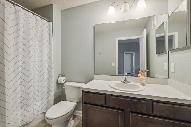 bathroom featuring walk in shower, vanity, a textured ceiling, and toilet