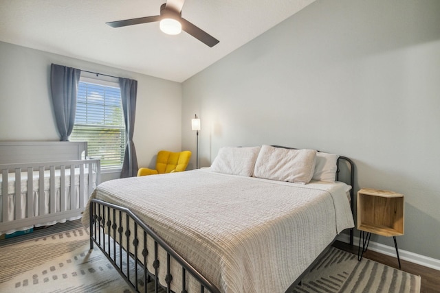 bedroom featuring wood-type flooring, vaulted ceiling, and ceiling fan