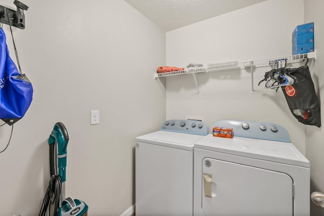 washroom featuring washer and dryer and a textured ceiling