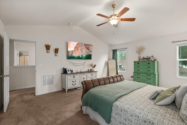 carpeted bedroom with ceiling fan and vaulted ceiling