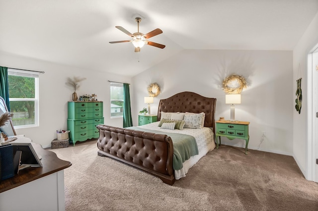 carpeted bedroom with ceiling fan and vaulted ceiling