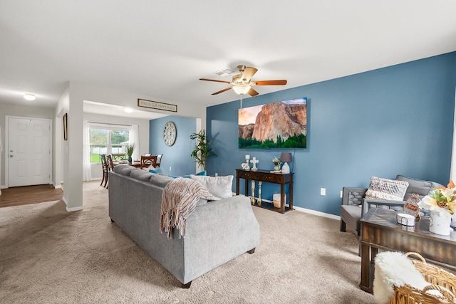 living room featuring carpet floors and ceiling fan