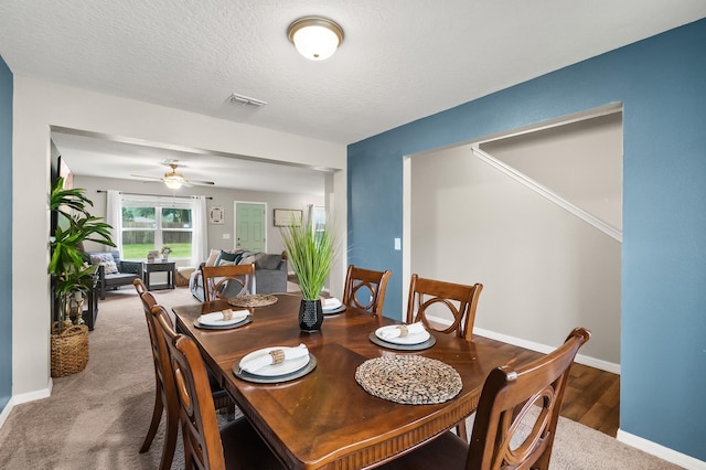 dining room with ceiling fan, carpet floors, and a textured ceiling