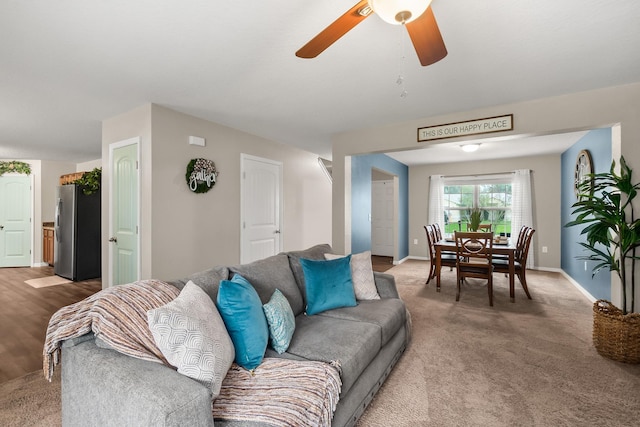 living room featuring carpet flooring and ceiling fan