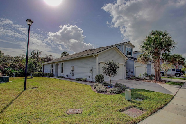 view of side of property featuring a yard and a garage