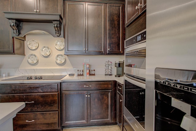 kitchen featuring dark brown cabinetry and stainless steel appliances