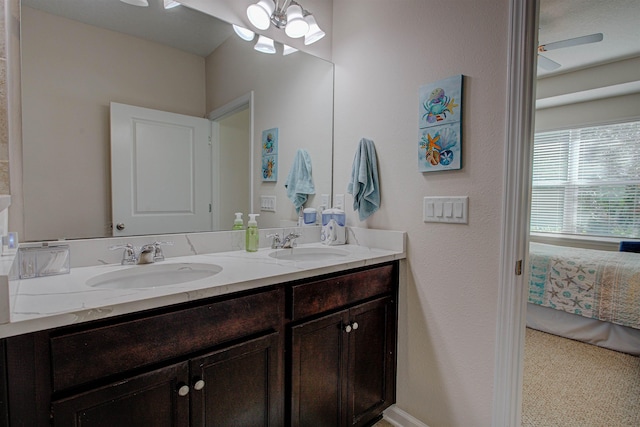 bathroom featuring vanity and ceiling fan with notable chandelier