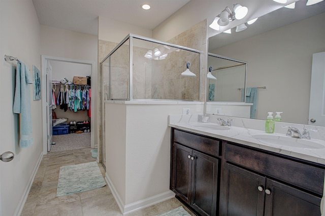 bathroom with tile patterned floors, vanity, and walk in shower