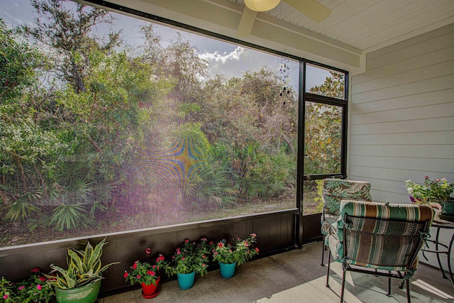 sunroom / solarium featuring ceiling fan