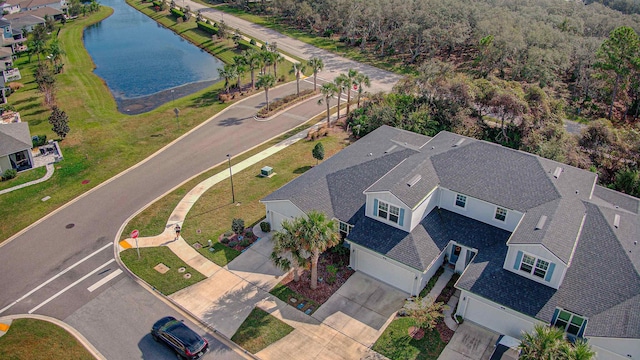 birds eye view of property with a water view