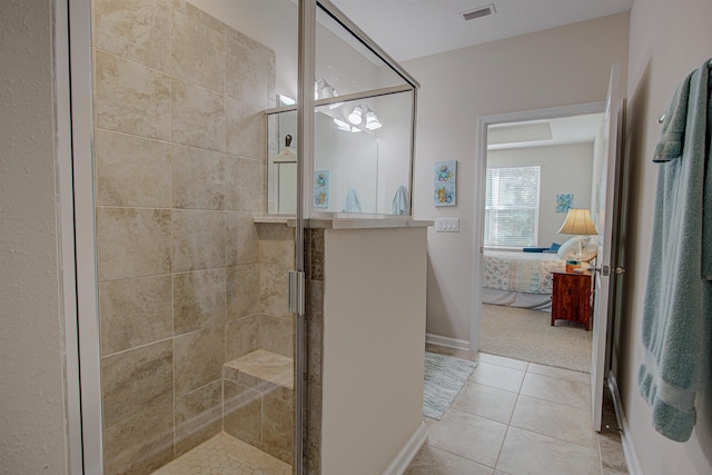 bathroom with tile patterned floors and an enclosed shower