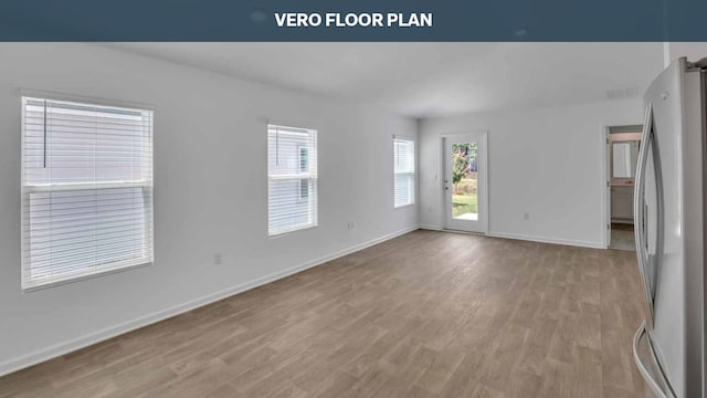 spare room with light hardwood / wood-style flooring