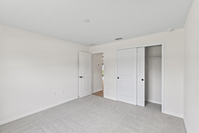 10 Reine Pl, Palm Coast, FL 32164 - unfurnished bedroom with carpet, baseboards, and a closet