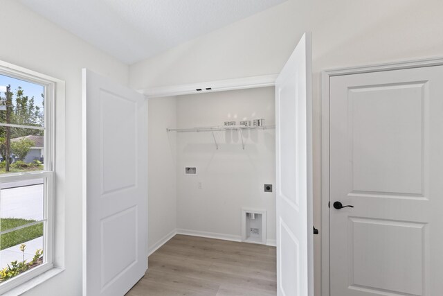 10 Reine Pl, Palm Coast, FL 32164 - laundry area featuring washer hookup, light wood-type flooring, electric dryer hookup, and baseboards