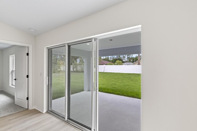 10 Reine Pl, Palm Coast, FL 32164 - doorway with light wood-style floors and baseboards