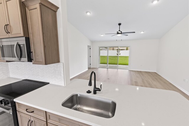 10 Reine Pl, Palm Coast, FL 32164 - kitchen featuring stainless steel microwave, black electric range, a sink, a ceiling fan, and light countertops